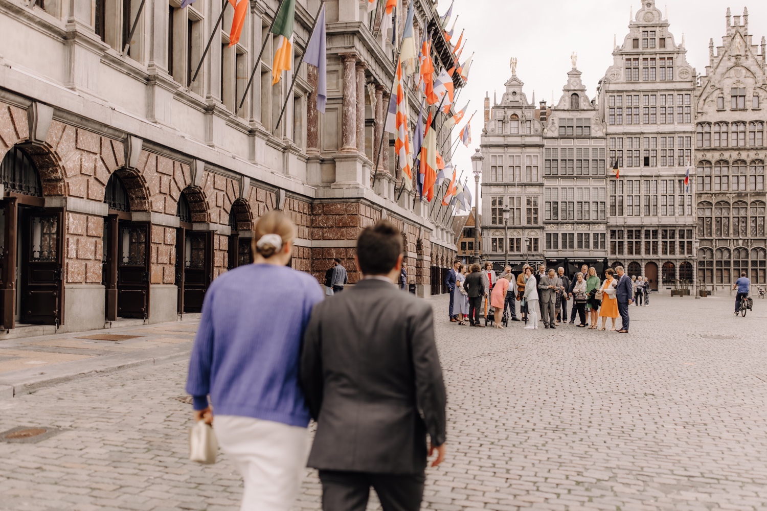 bruidspaar wandelt naar hun familie aan het stadhuis van Antwerpen