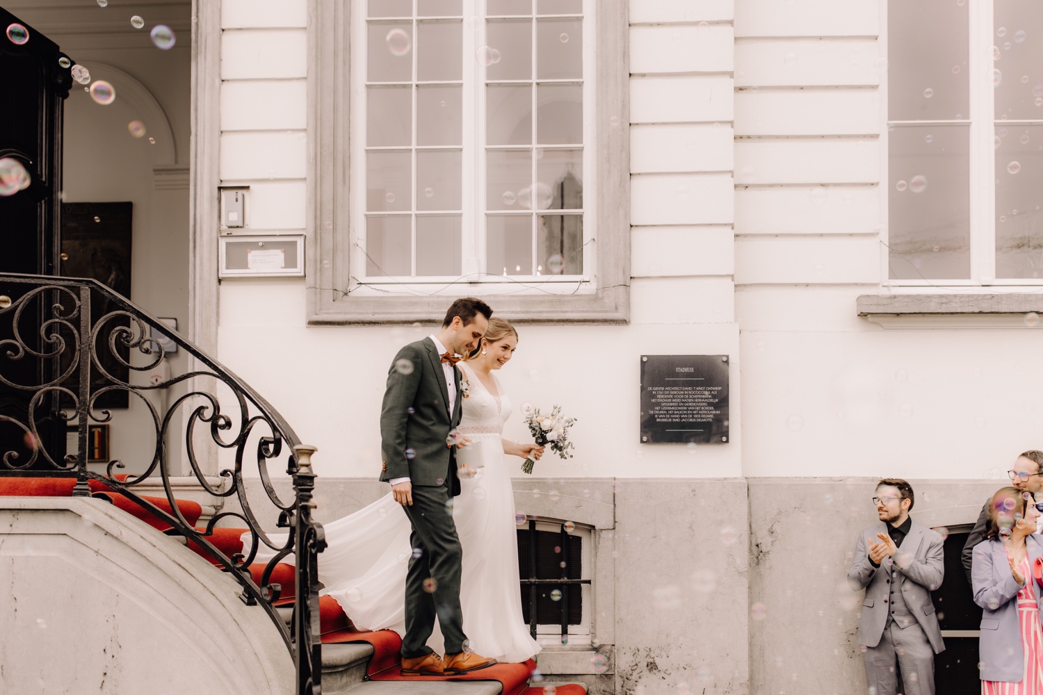 Huwelijksfotograaf Limburg - bruidspaar wandelt uit gemeentehuis