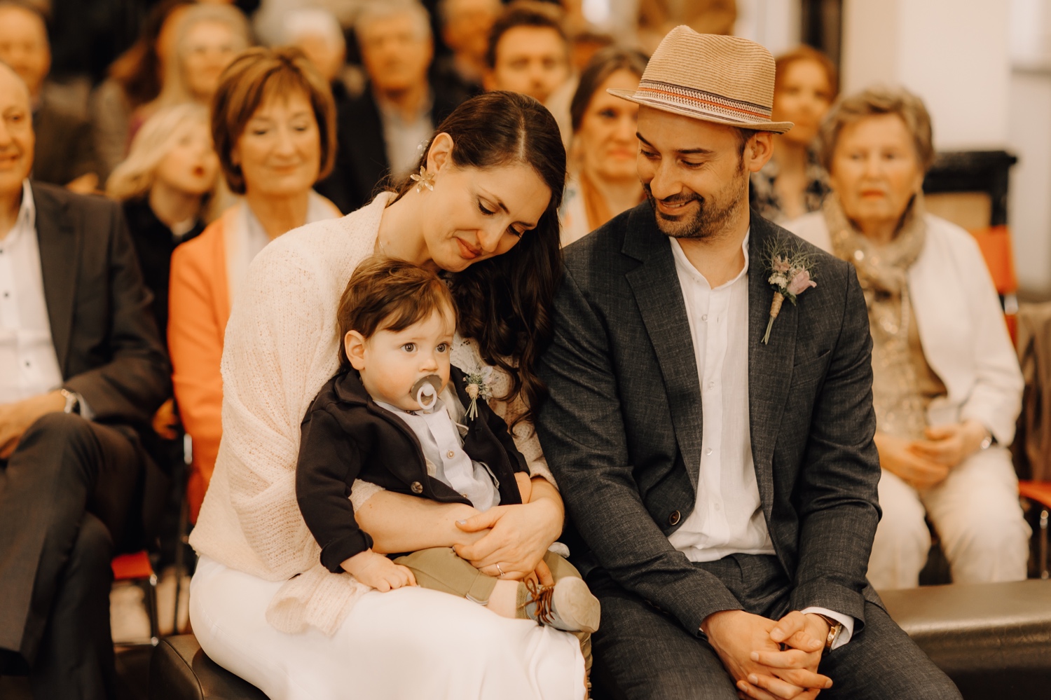 Huwelijksfotograaf Limburg - bruidspaar zit samen met zoontje in gemeentehuis Antverpia te Brasschaat